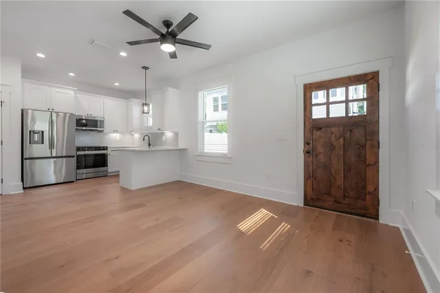 a view of kitchen with windows and refrigerator