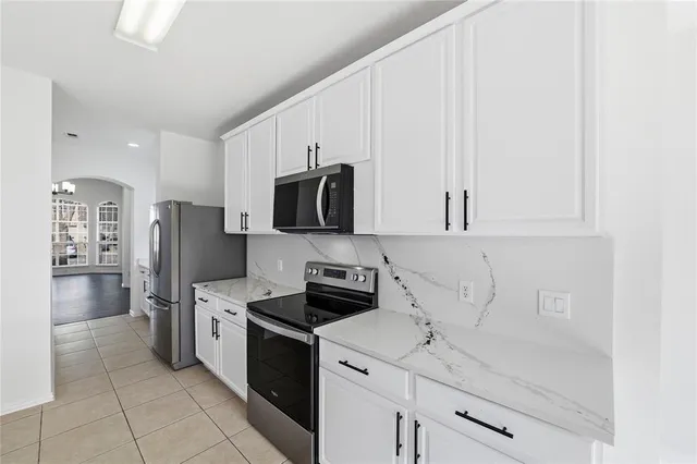 a kitchen with stainless steel appliances a refrigerator stove and microwave