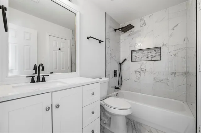 a bathroom with a sink a toilet and a bathtub