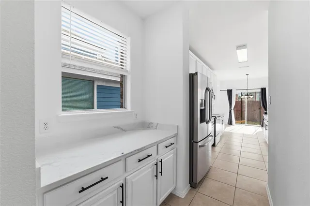 a hallway with a sink and a refrigerator