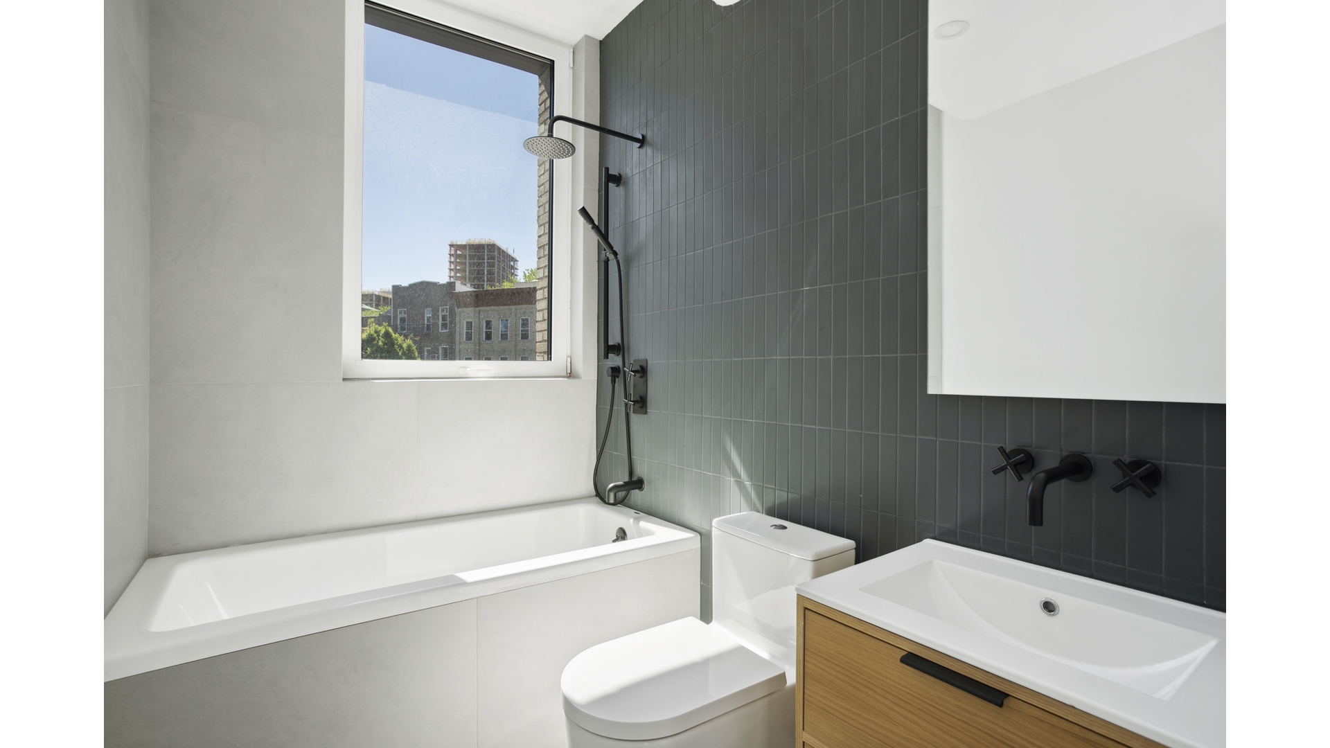 128 Woodpoint Road, Unit 2A Brooklyn, NY 11211 - Photo 11 of 15 a bathroom with a sink a toilet and a bathtub