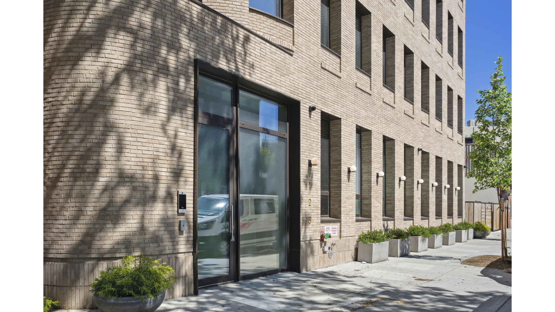 128 Woodpoint Road, Unit 2A Brooklyn, NY 11211 - Photo 14 of 15 a view of a brick building with many windows