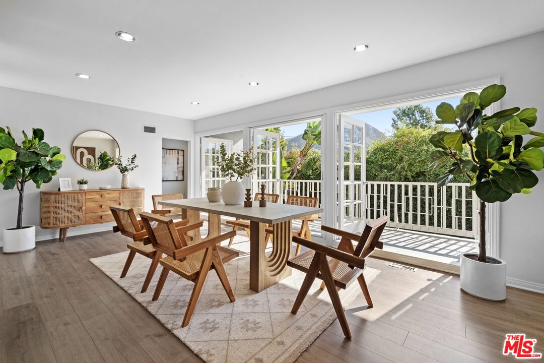 a view of a dining room with furniture window and wooden floor