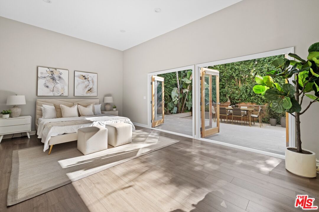 3366 Troy Drive Los Angeles, CA 90068 - Photo 13 of 24 a spacious bedroom with a bed a table and a potted plant