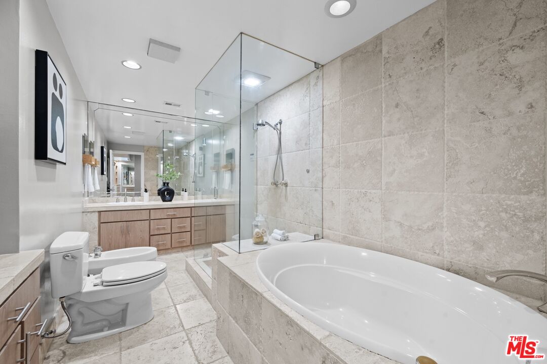 3366 Troy Drive Los Angeles, CA 90068 - Photo 16 of 24 a large white bathroom with a granite countertop sink a toilet a mirror and bathtub