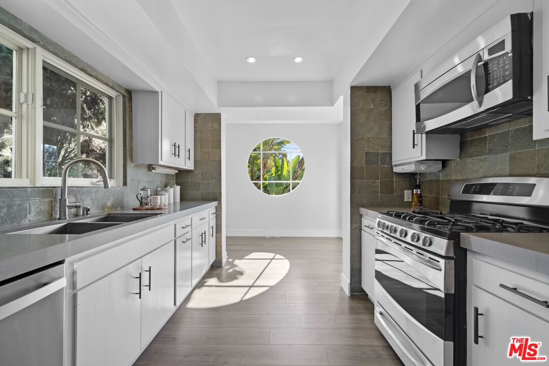 3366 Troy Drive Los Angeles, CA 90068 - Photo 8 of 24 a kitchen with stainless steel appliances a stove cabinets and a sink