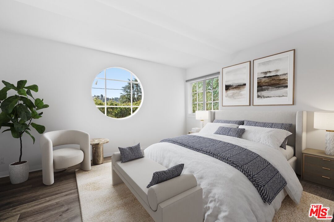 3366 Troy Drive Los Angeles, CA 90068 - Photo 9 of 24 a bedroom with a large bed a couch and a potted plant