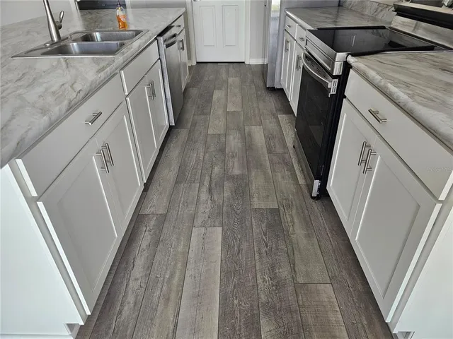a view of a kitchen from stairs