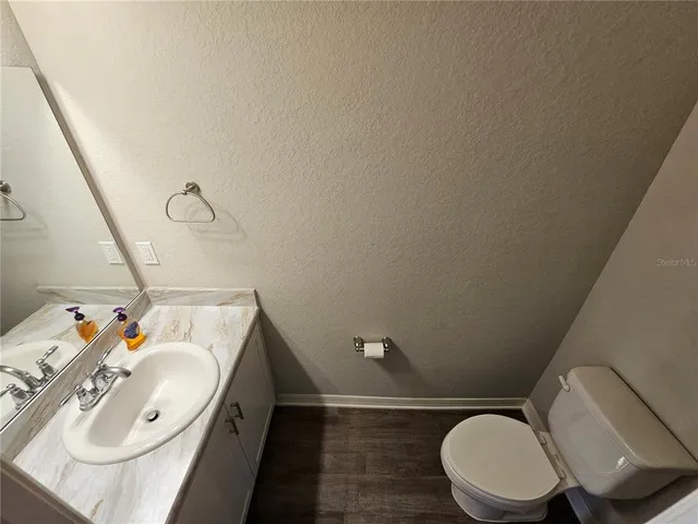 a bathroom with a sink toilet and mirror