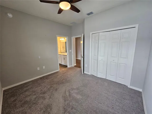 an empty room with closet and entryway
