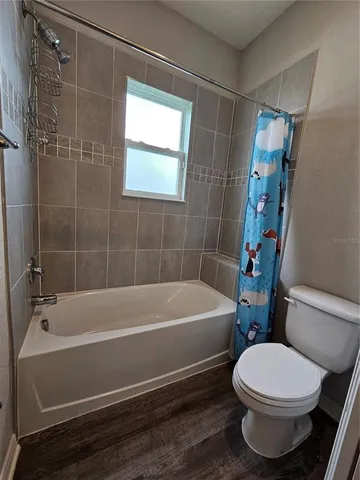 a bathroom with a toilet and a bath tub
