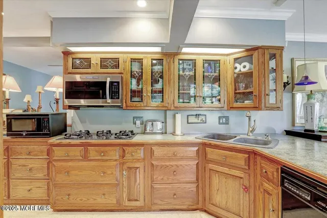 a kitchen with stainless steel appliances granite countertop a sink stove and cabinets