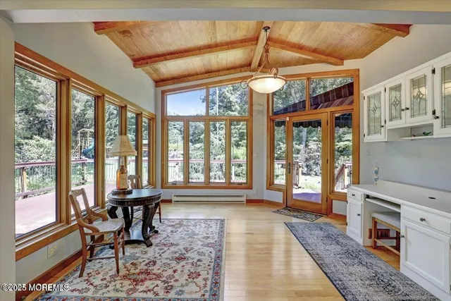 a dining room with wooden floor and a rug