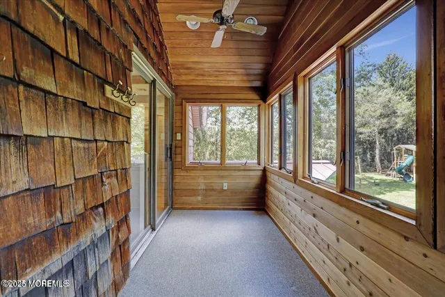 a view of room with window and book shelf