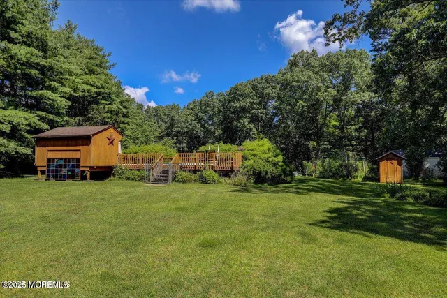 a view of a house with a yard and sitting area