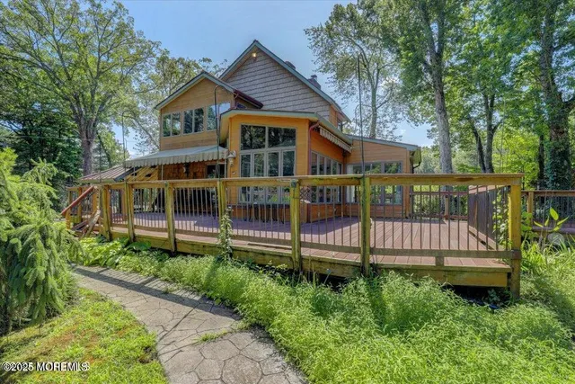 a front view of a house with a yard and deck