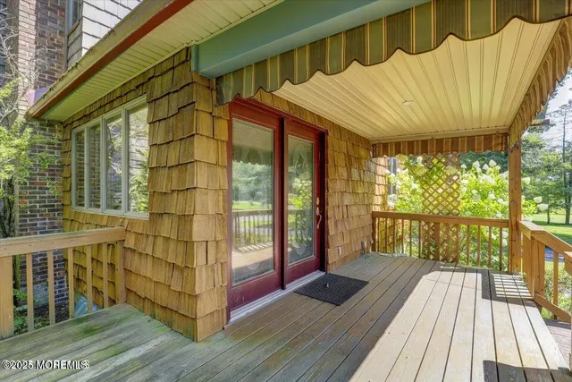 a view of a balcony with wooden floor and iron stairs