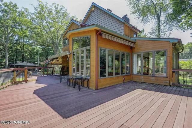 a view of a house with wooden floor and wooden fence
