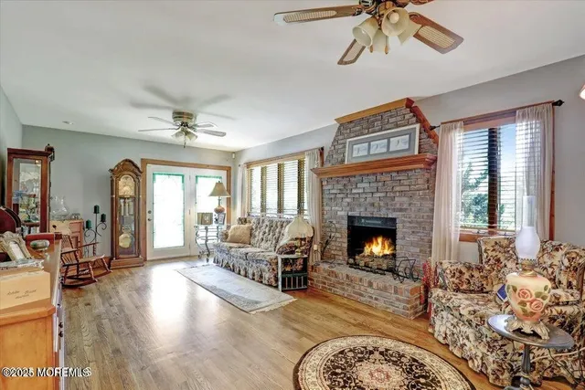 a living room with furniture fireplace and window