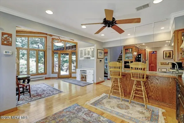 a living room with furniture a flat screen tv and a large window