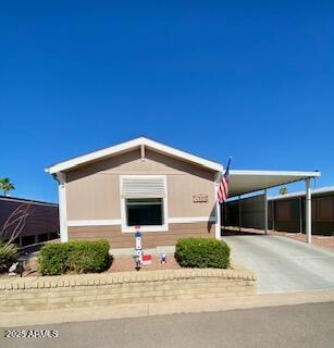 11101 East University Drive, Unit 125 Apache Junction, AZ 85120 - Photo 1 of 32 a front view of a house with a yard and garage