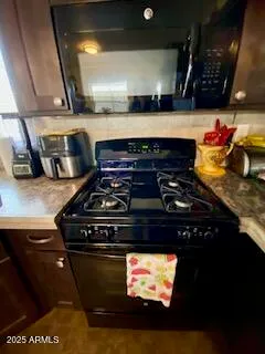 a stove top oven sitting inside of a kitchen