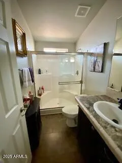 a bathroom with a granite countertop sink toilet and a mirror