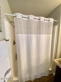 a bathroom with a shower and a tub