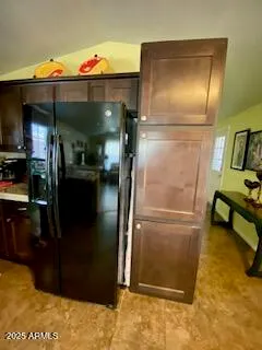 a kitchen with refrigerator and table