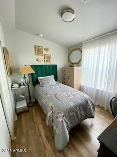 a bedroom with a bed and window