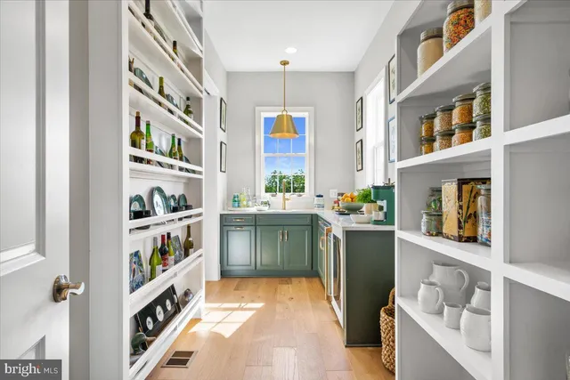 a kitchen with stainless steel appliances cabinets and a book shelf