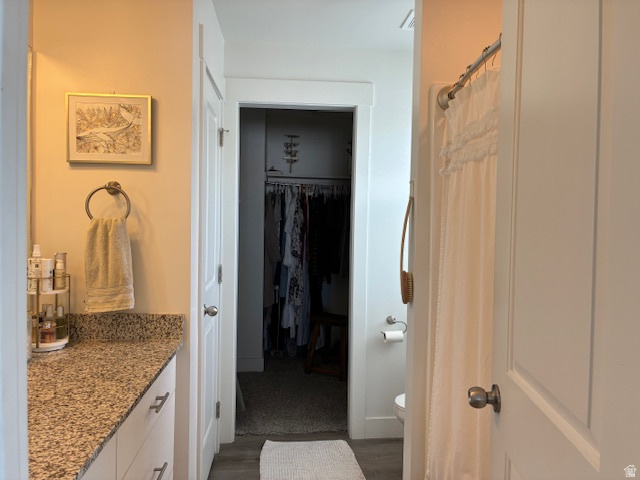 1249 West 1820th Street South Logan, UT 84321 - Photo 10 of 15 Full bathroom with vanity, curtained shower, a walk in closet, and dark wood-style flooring