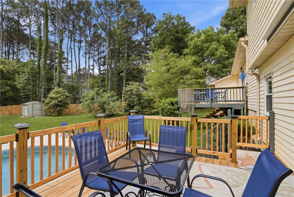 338 Arbour Way Suwanee, GA 30024 - Photo 21 of 32 a view of a chair and table on the deck