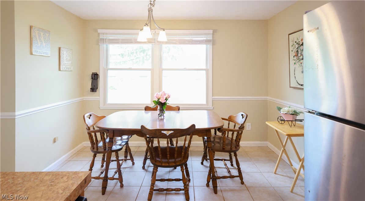 834 Wadsworth Road, Unit B1 Medina, OH 44256 - Photo 4 of 23 Tiled dining space featuring a chandelier