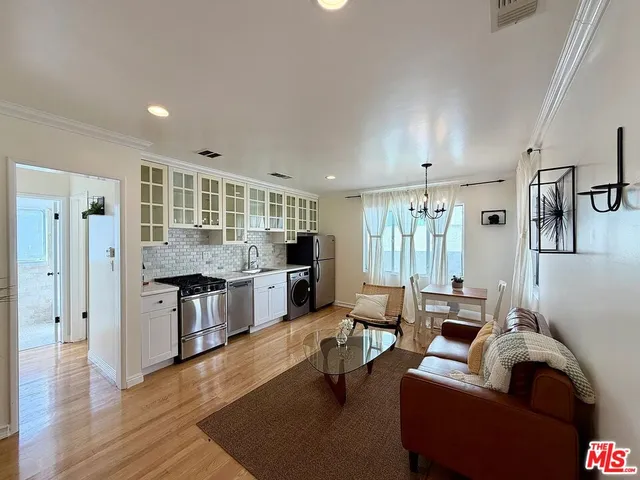 a living room with furniture and kitchen view