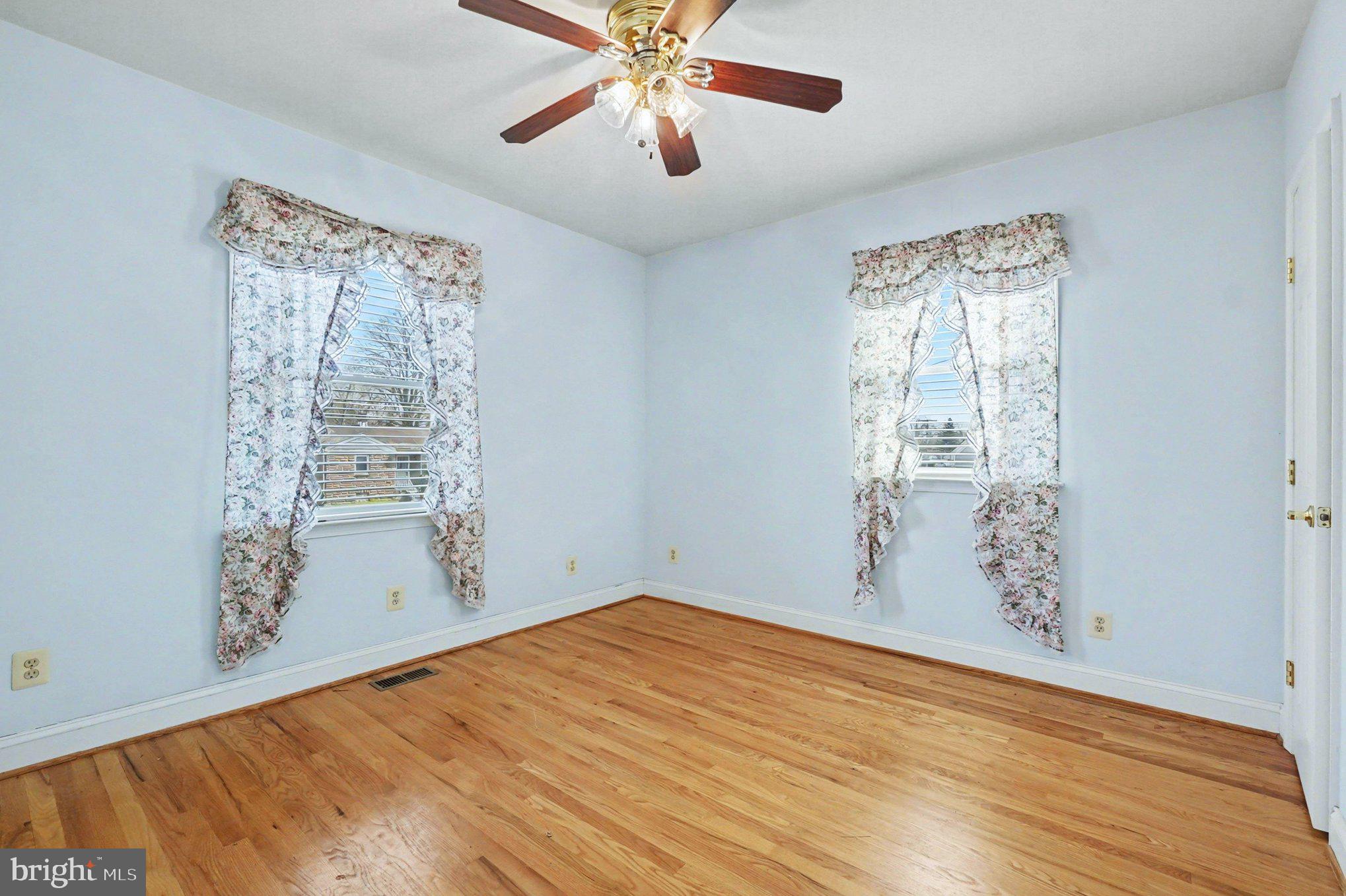 7908 Oakleigh Road Baltimore, MD 21234 - Photo 14 of 41 a view of empty room with wooden floor and fan