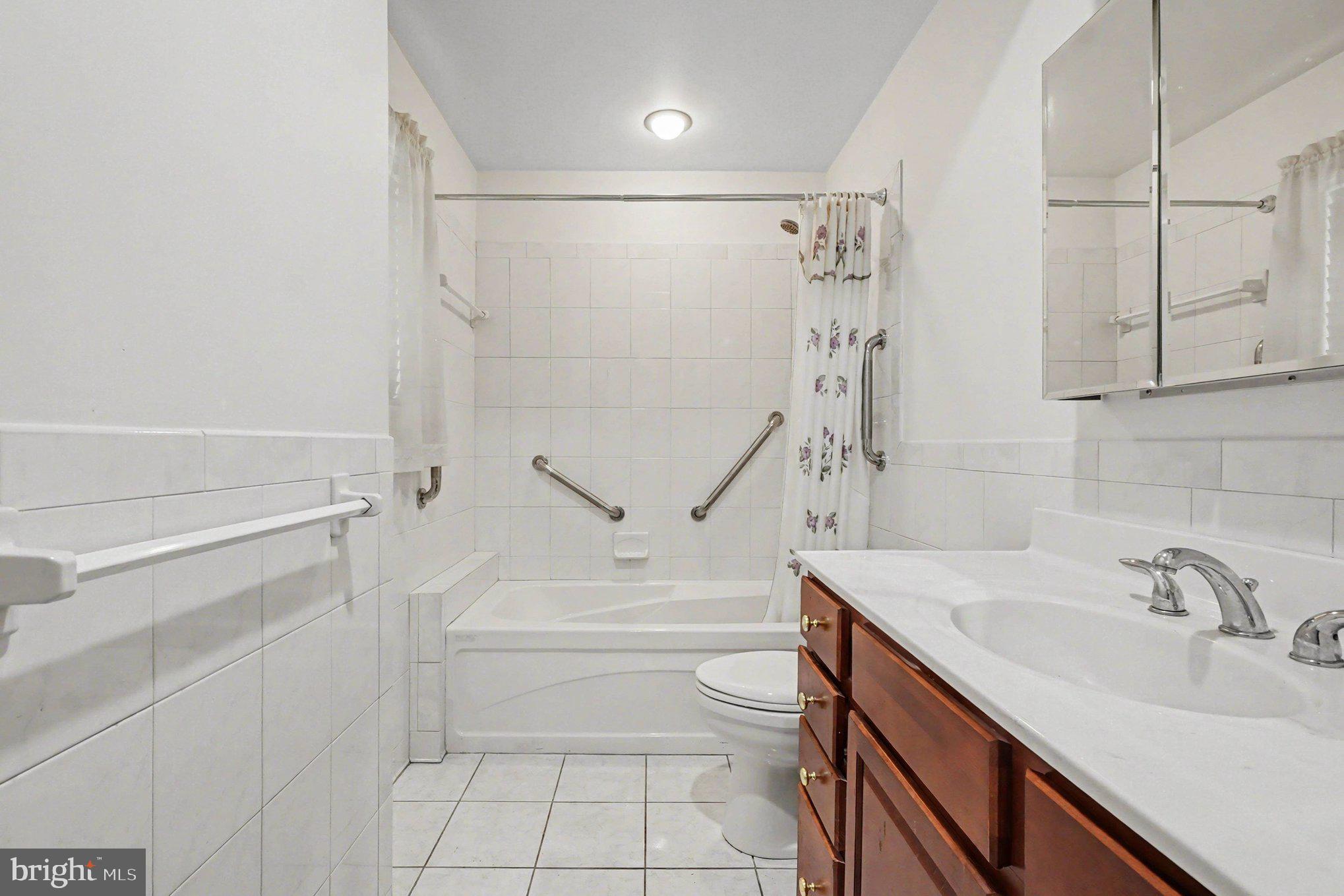 7908 Oakleigh Road Baltimore, MD 21234 - Photo 17 of 41 a bathroom with a sink a toilet and shower