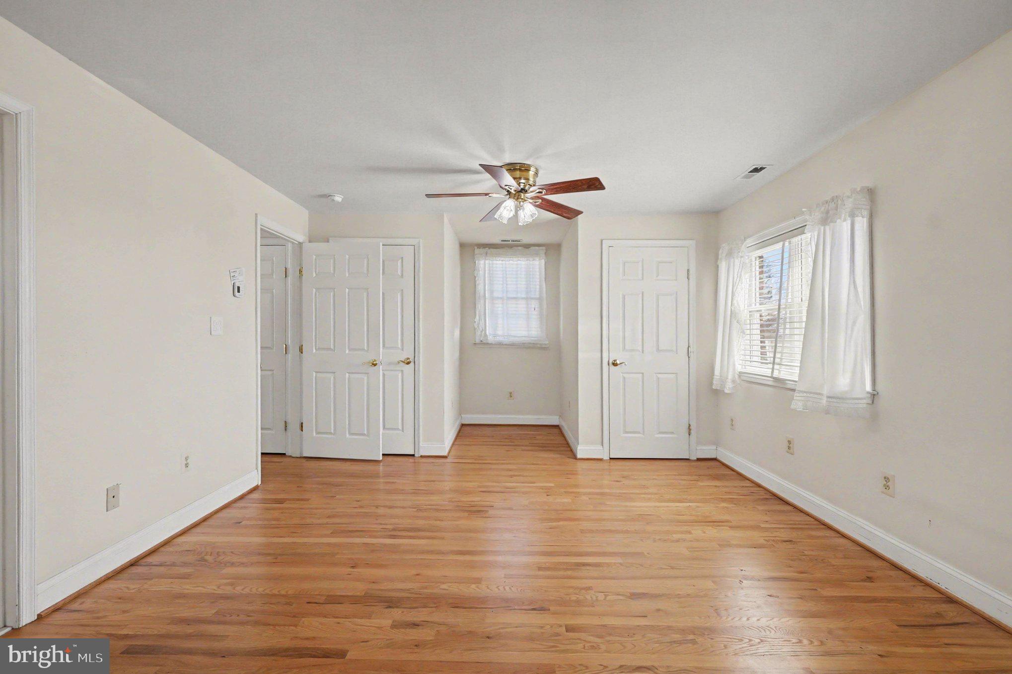 7908 Oakleigh Road Baltimore, MD 21234 - Photo 18 of 41 a view of an empty room with window and wooden floor