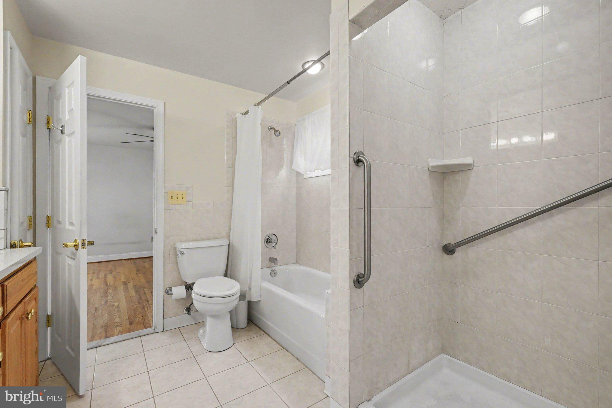 7908 Oakleigh Road Baltimore, MD 21234 - Photo 20 of 41 a bathroom with a toilet tub and shower
