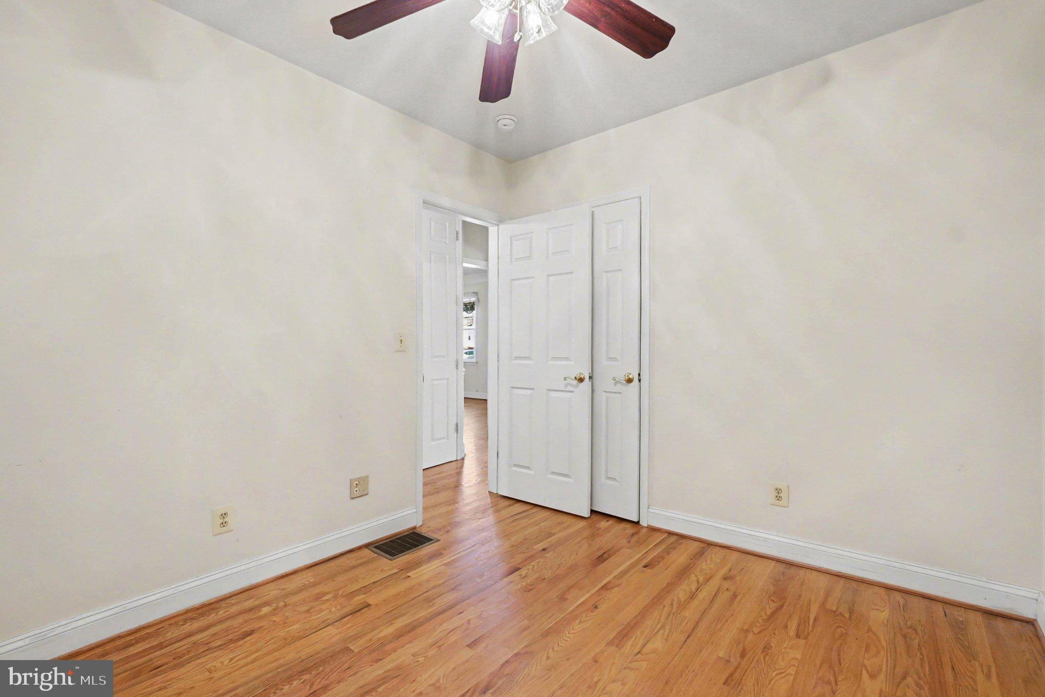 7908 Oakleigh Road Baltimore, MD 21234 - Photo 24 of 41 a view of an empty room with wooden floor