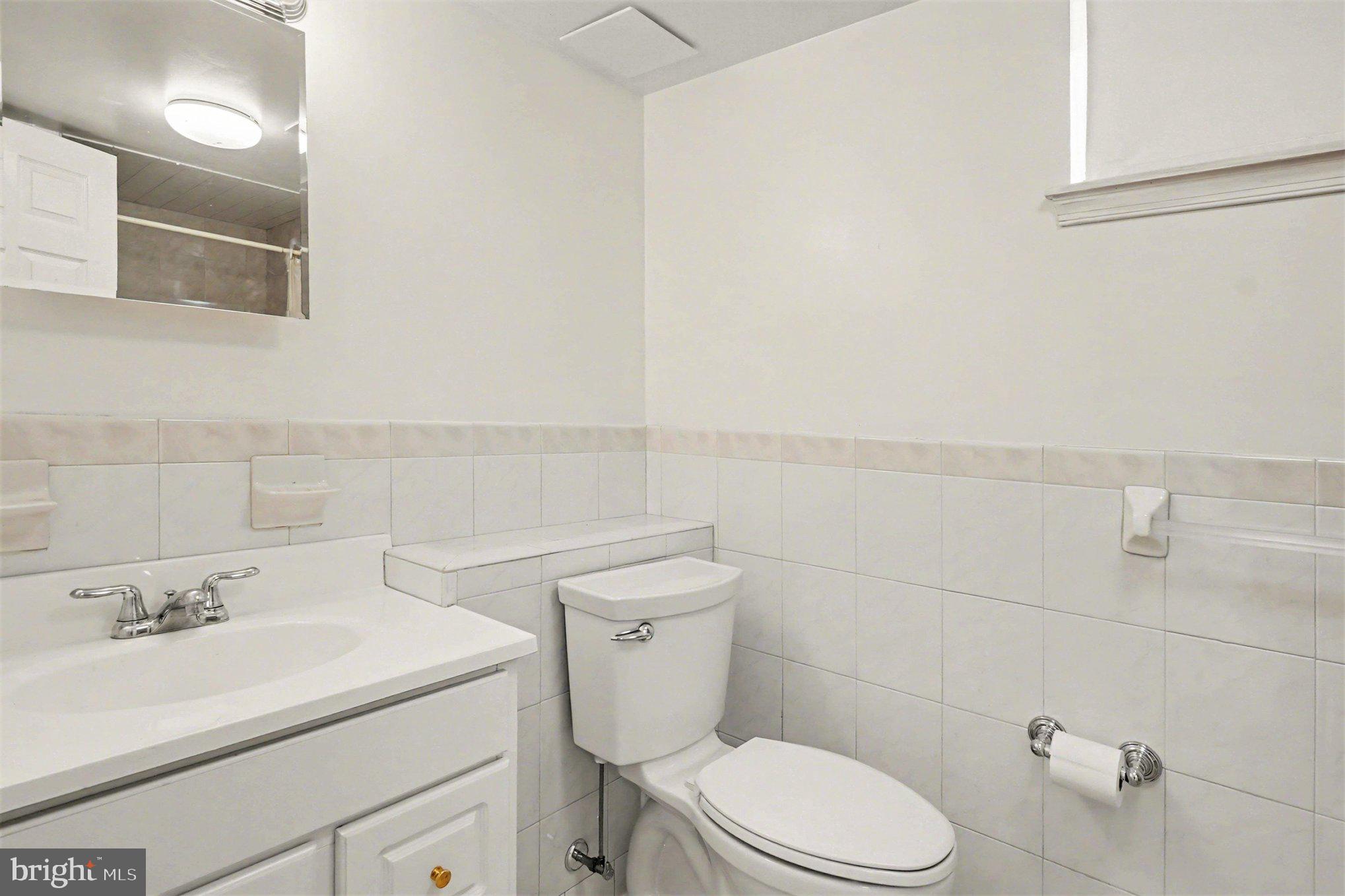 7908 Oakleigh Road Baltimore, MD 21234 - Photo 27 of 41 a bathroom with a sink a toilet and a mirror