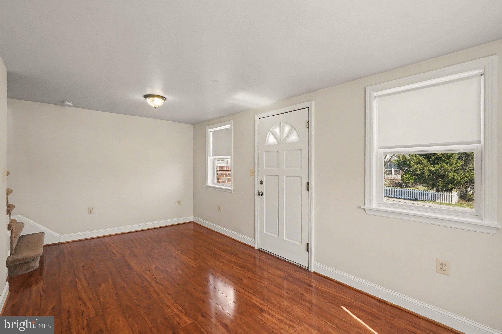 7908 Oakleigh Road Baltimore, MD 21234 - Photo 32 of 41 an empty room with wooden floor and windows