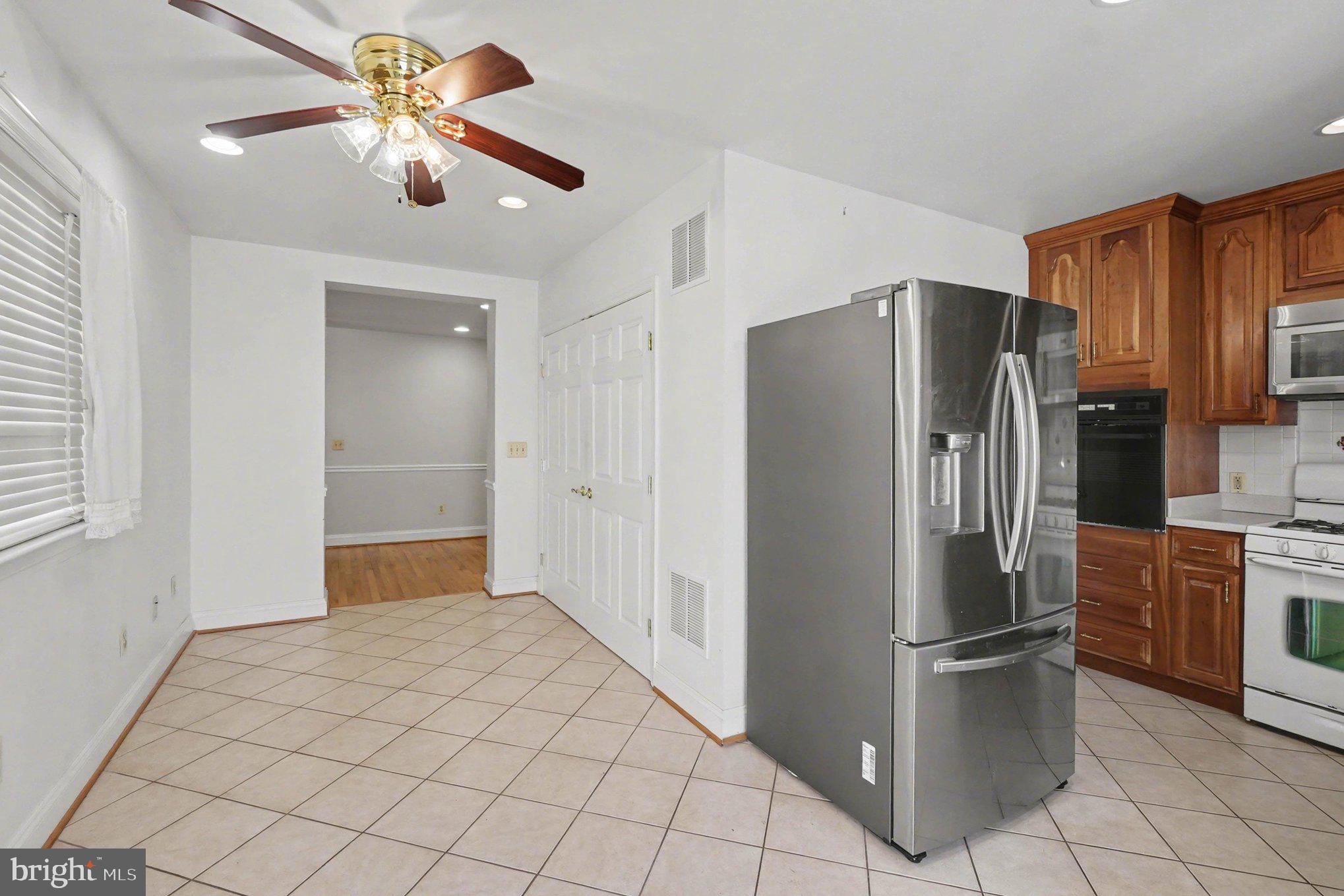 7908 Oakleigh Road Baltimore, MD 21234 - Photo 10 of 41 a kitchen with stainless steel appliances a refrigerator and a stove top oven