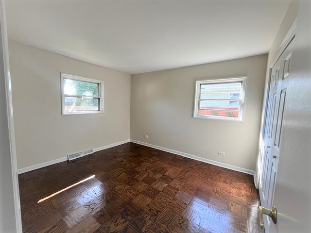 539 Ridgewood Road Elk Grove Village, IL 60007 - Photo 11 of 15 an empty room with wooden floor and windows