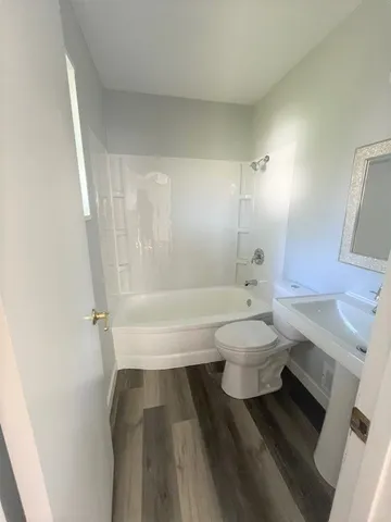 a bathroom with a toilet a sink and bathtub
