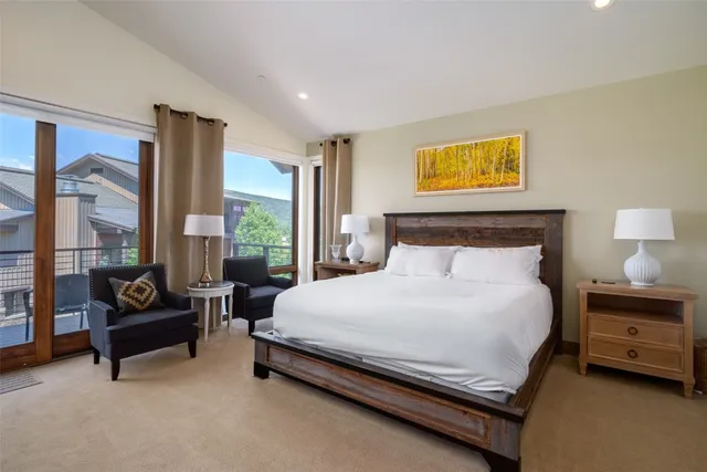 a bedroom with a bed and large window