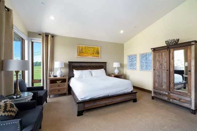 a bedroom with furniture and flat screen tv