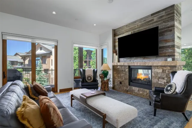 a living room with furniture a flat screen tv and a fireplace