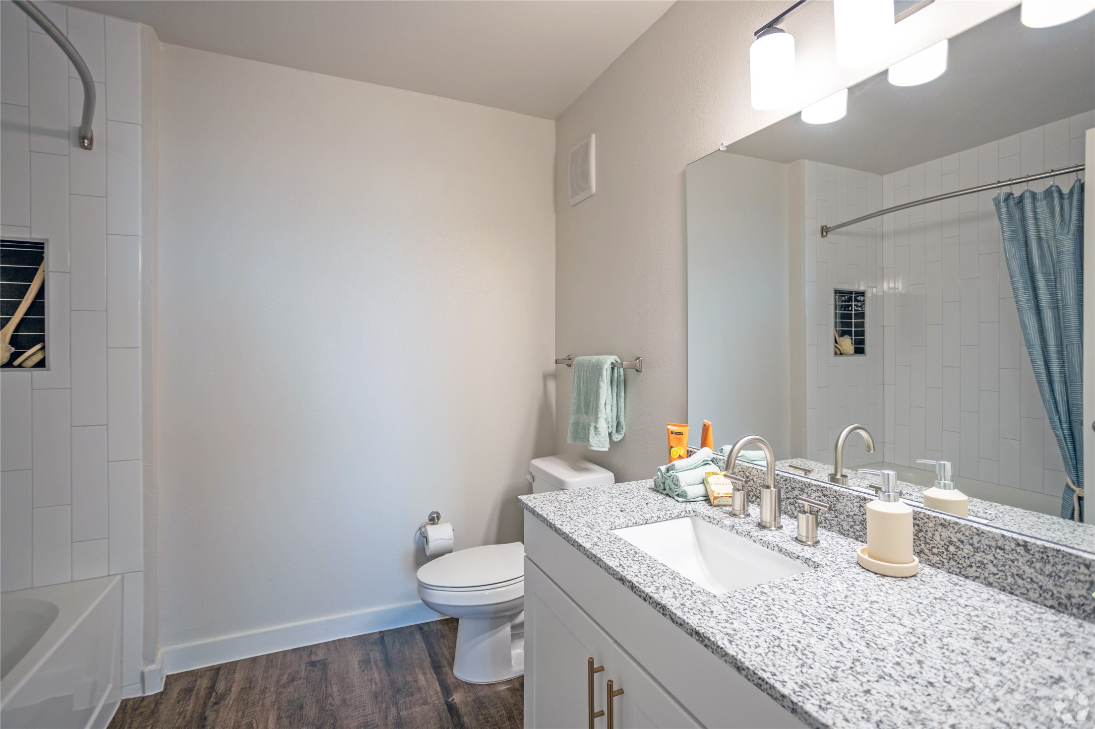 10010 North Capital Of Texas Highway, Unit 116 Austin, TX 78759 - Photo 12 of 20 a bathroom with a granite countertop sink a toilet and a mirror