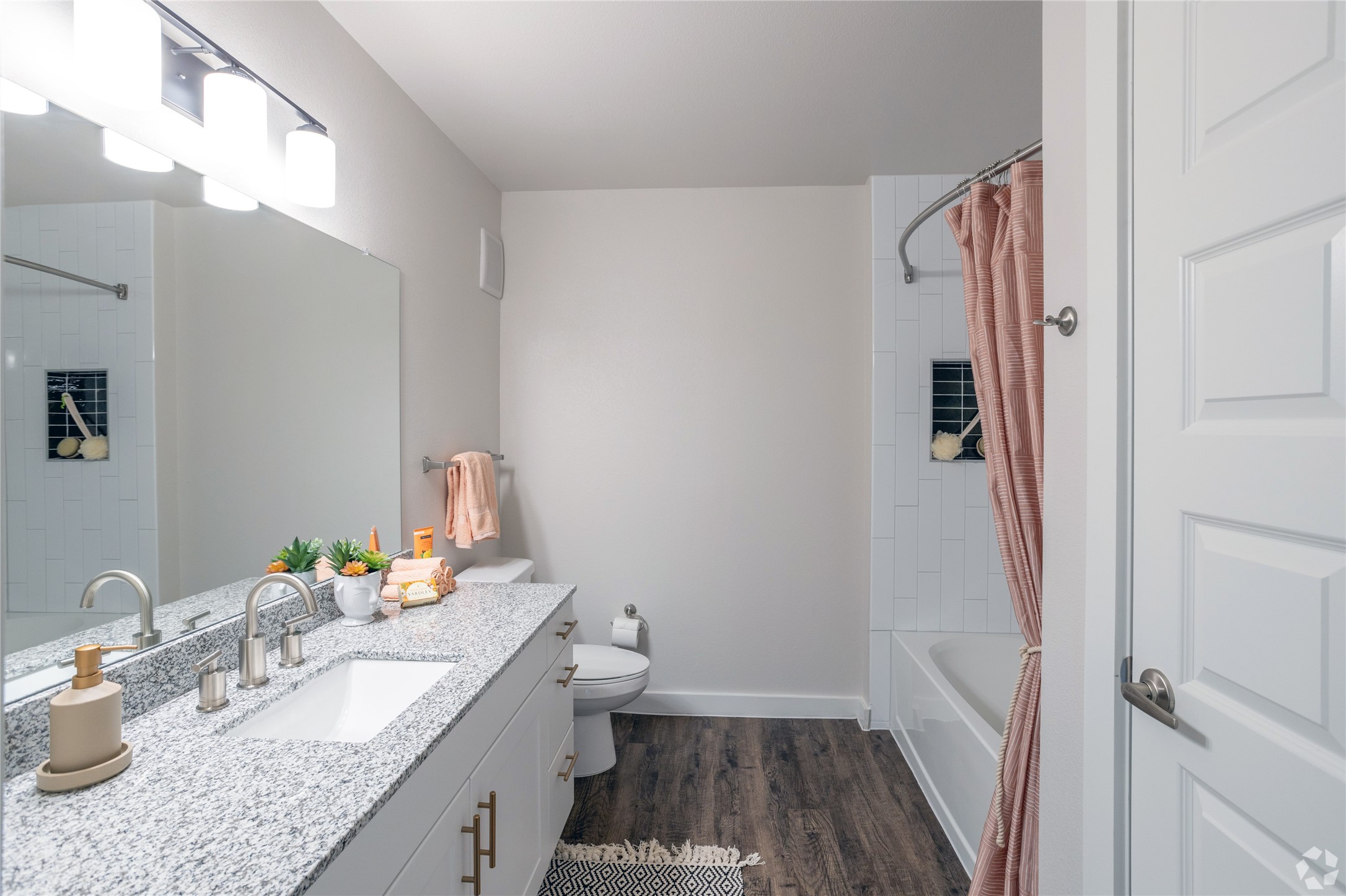 10010 North Capital Of Texas Highway, Unit 116 Austin, TX 78759 - Photo 14 of 20 a bathroom with a granite countertop sink a mirror and a toilet